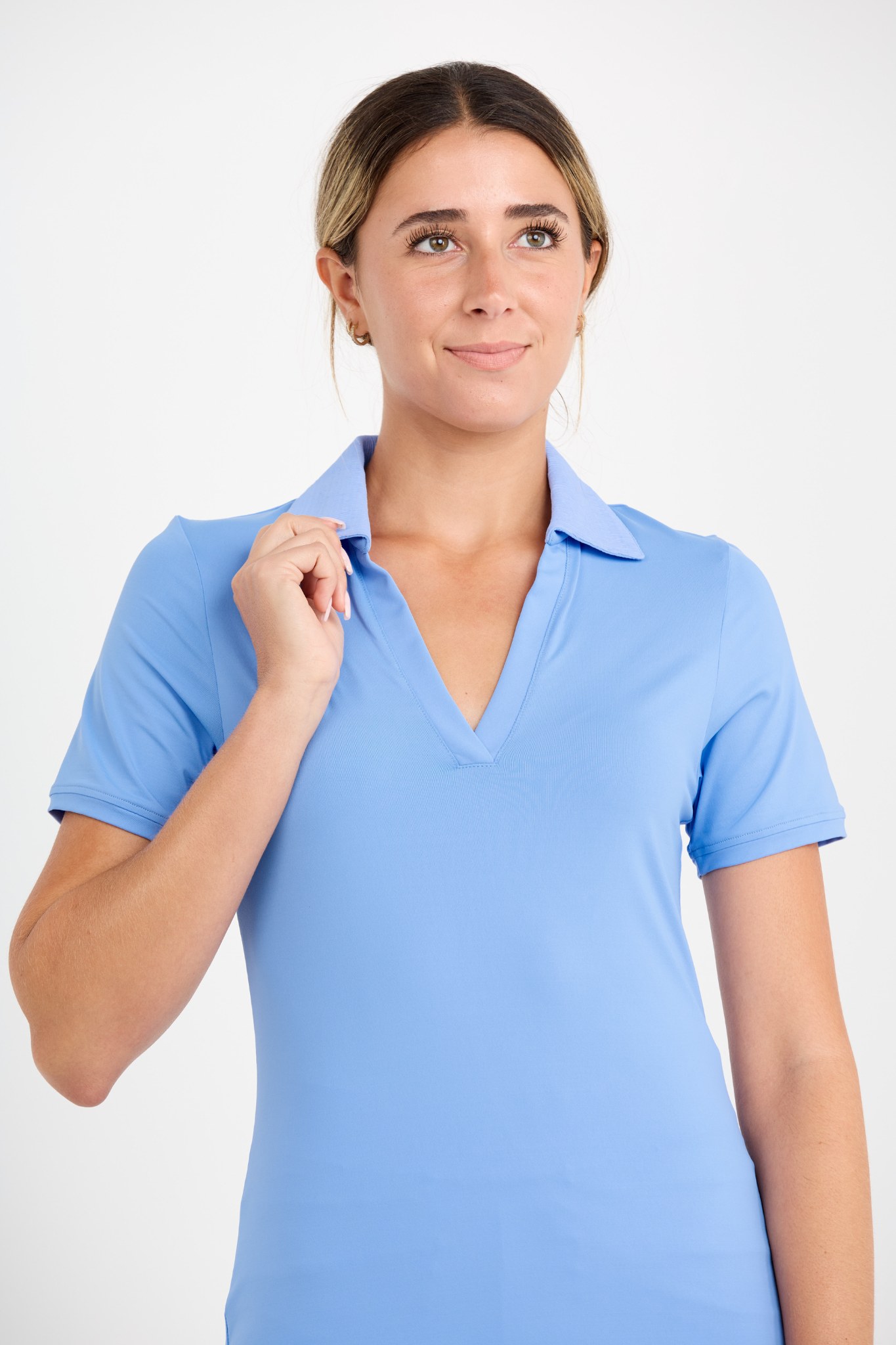 Women's Periwinkle Short Sleeve Golf Polo Top by Sofibella, close up view on model