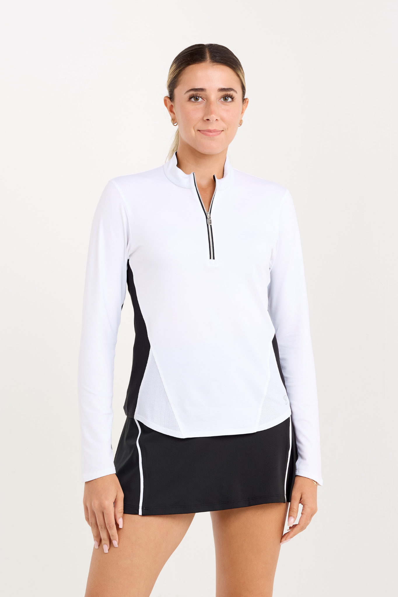 Women's white long sleeve tennis top with black mesh, close up view